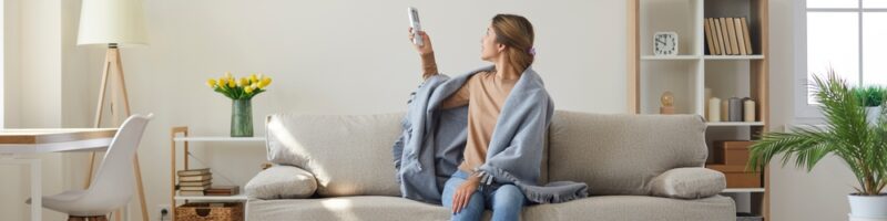 Woman,Who's,Sitting,On,Sofa,Under,Warm,Plaid,In,Living