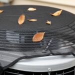 House,Air,Conditioning,Unit,With,Protective,Mesh,Cover,During,Fall