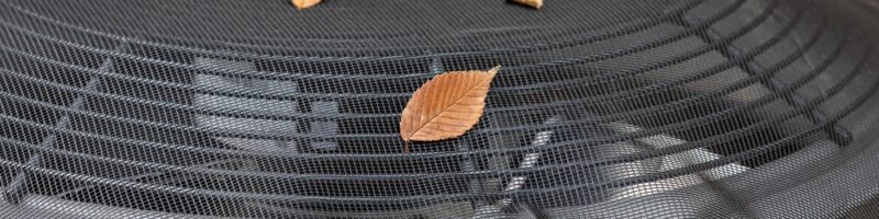 House,Air,Conditioning,Unit,With,Protective,Mesh,Cover,During,Fall