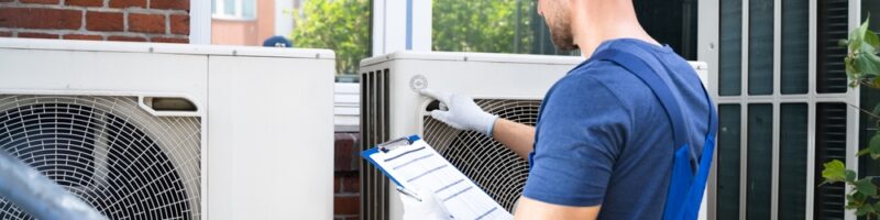 Two,Electricians,Men,Wearing,Safety,Jackets,Checking,Air,Conditioning,Unit