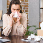 Young,Businesswoman,Suffering,From,Allergy,At,Workplace